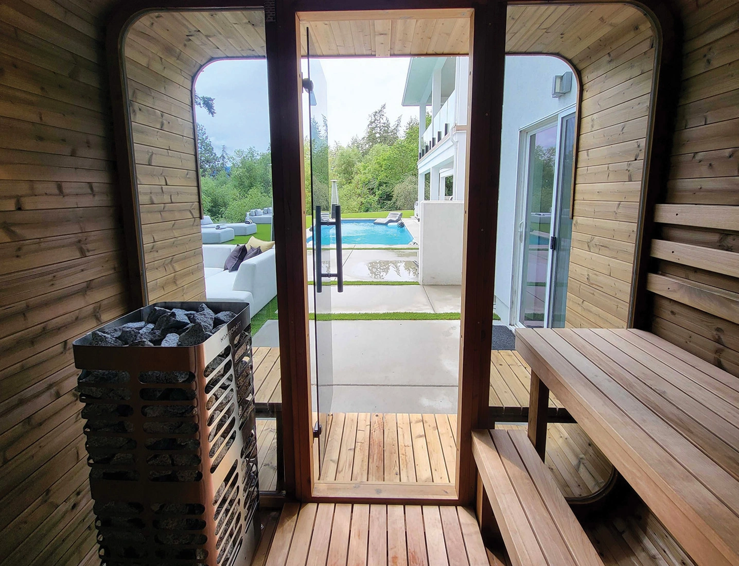 Thermory Sauna Square with homecraft heater looking out from inside